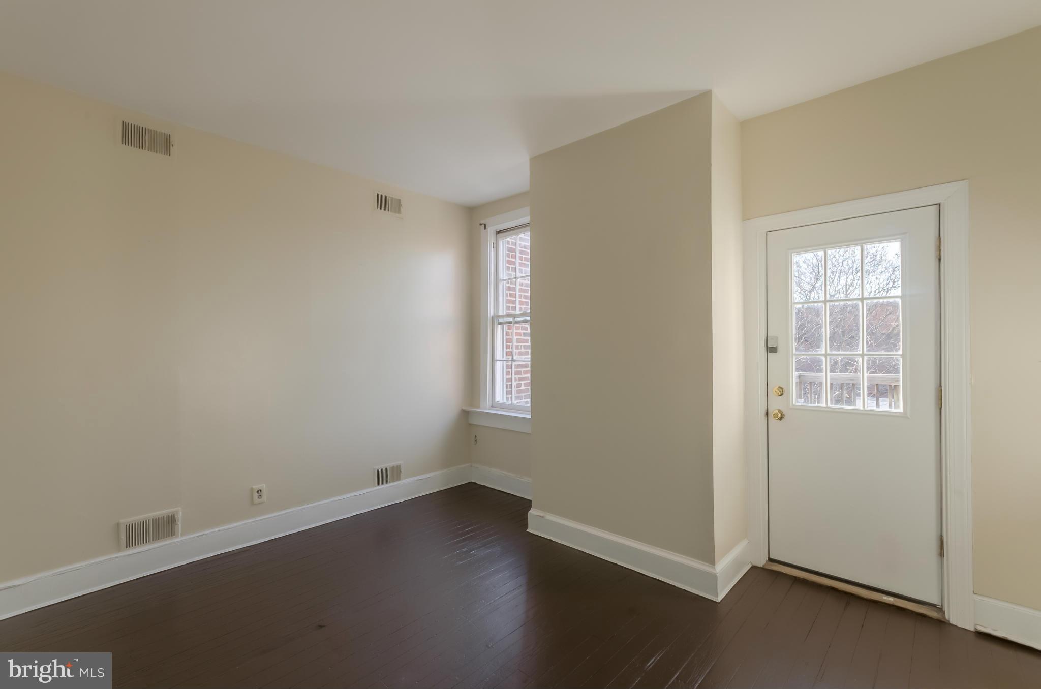 10 7th Street Northeast Washington, DC 20002 - Photo 20 of 30 an empty room with wooden floor and windows