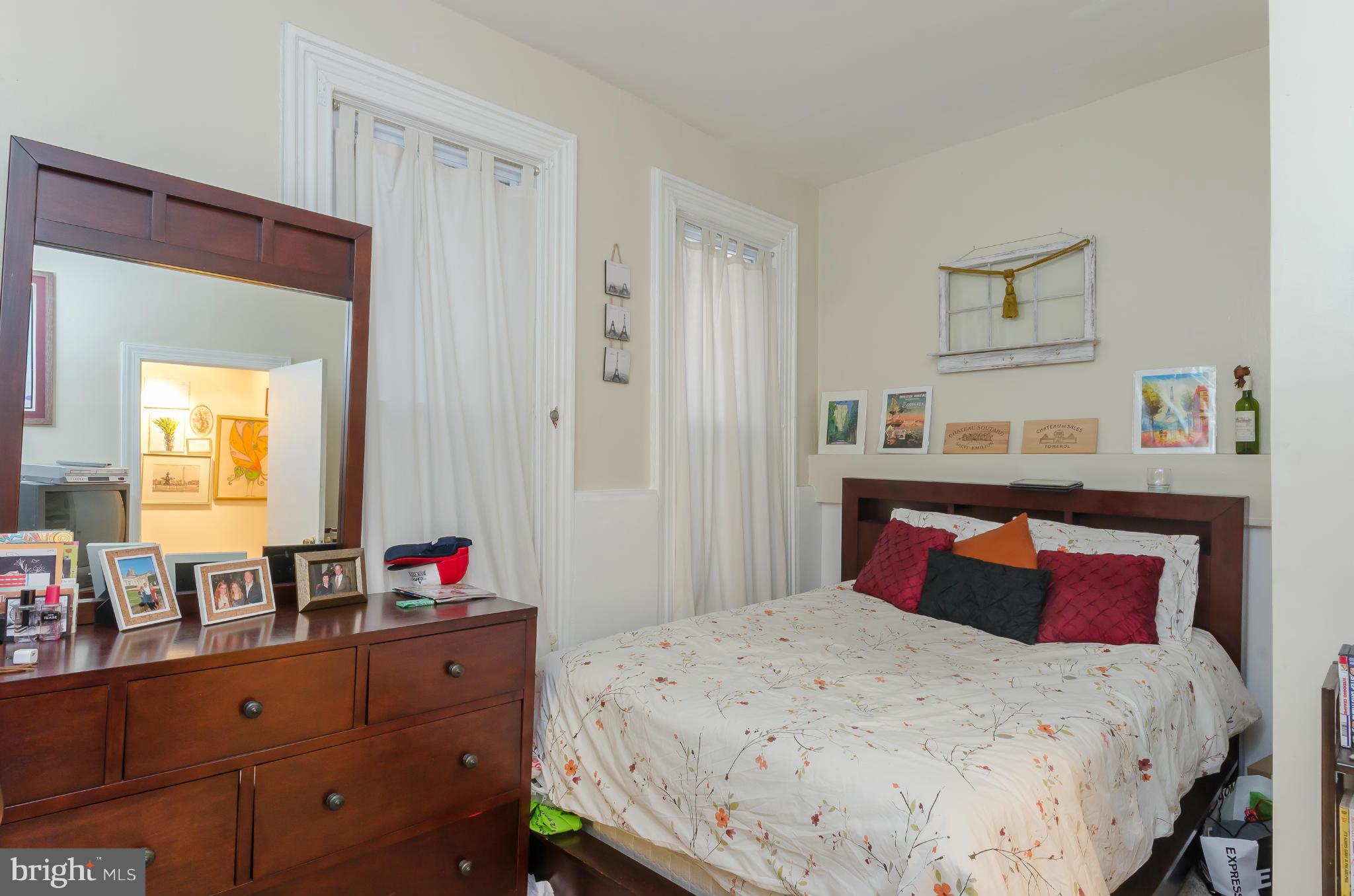 10 7th Street Northeast Washington, DC 20002 - Photo 7 of 30 a bedroom with a bed and a dresser in it