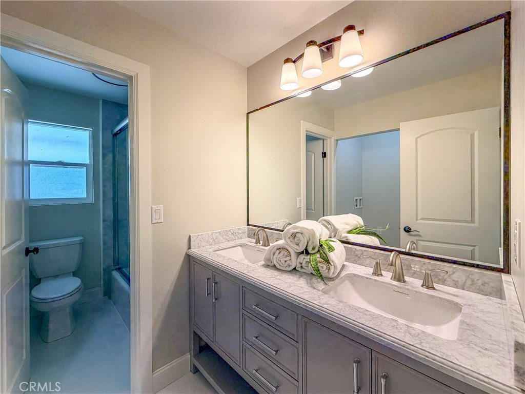 374 Stilson Canyon Road Chico, CA 95928 - Photo 14 of 37 a bathroom with a granite countertop sink a toilet and a mirror