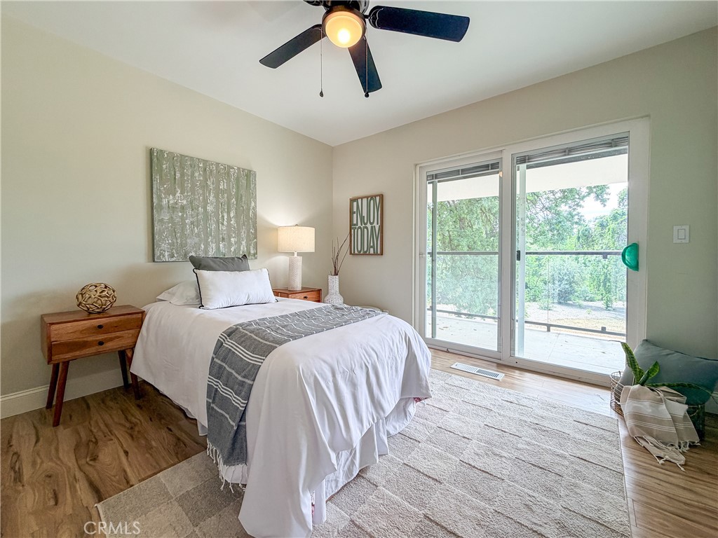 374 Stilson Canyon Road Chico, CA 95928 - Photo 15 of 37 a bedroom with a bed and wooden floor
