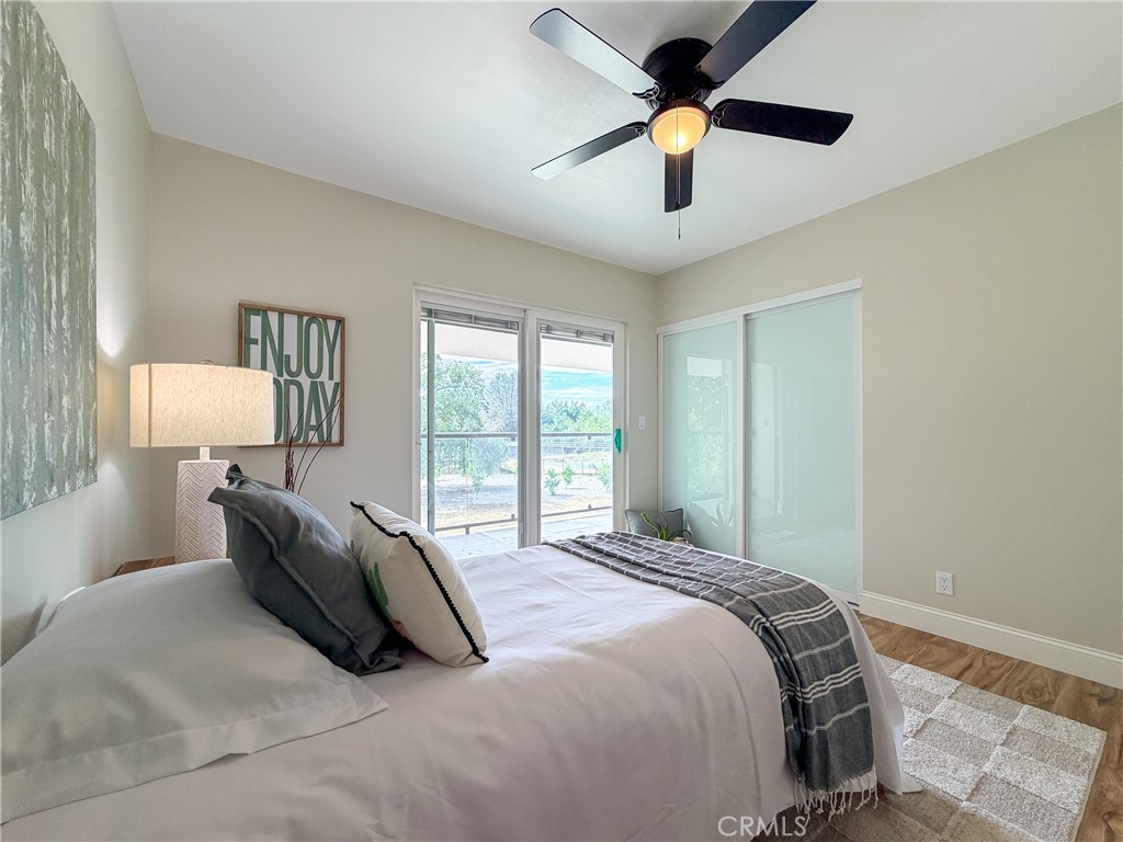 374 Stilson Canyon Road Chico, CA 95928 - Photo 16 of 37 a bedroom with a bed and a chandelier