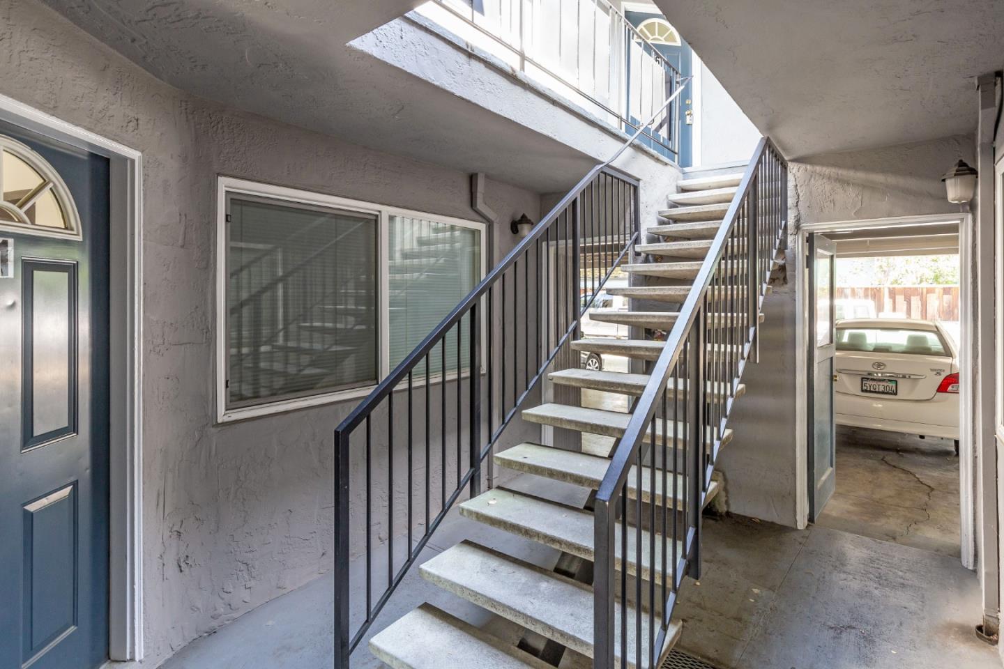 759 Middlefield Road Palo Alto, CA 94301 - Photo 22 of 35 a view of staircase with lots of frames on wall and windows