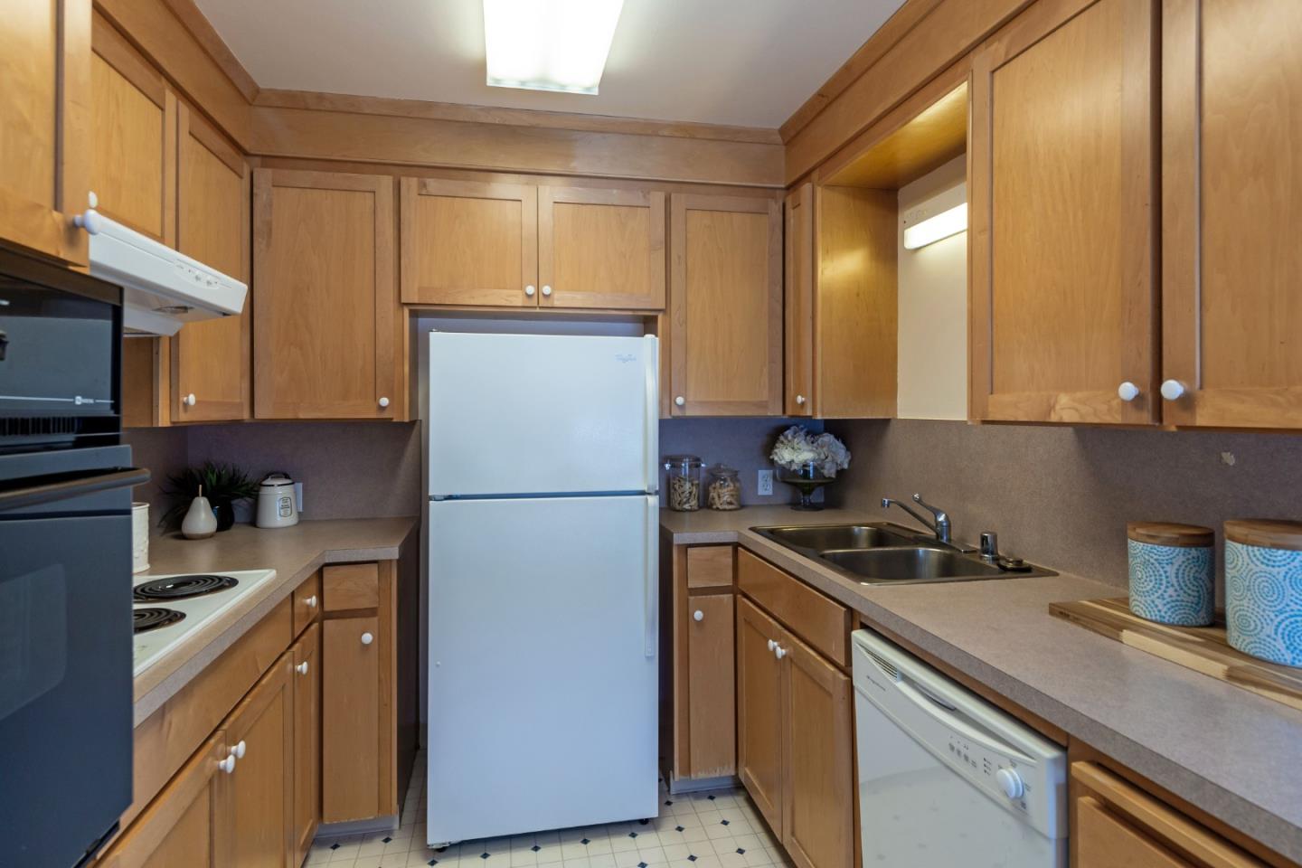 759 Middlefield Road Palo Alto, CA 94301 - Photo 10 of 35 a kitchen with a refrigerator a stove a sink and cabinets