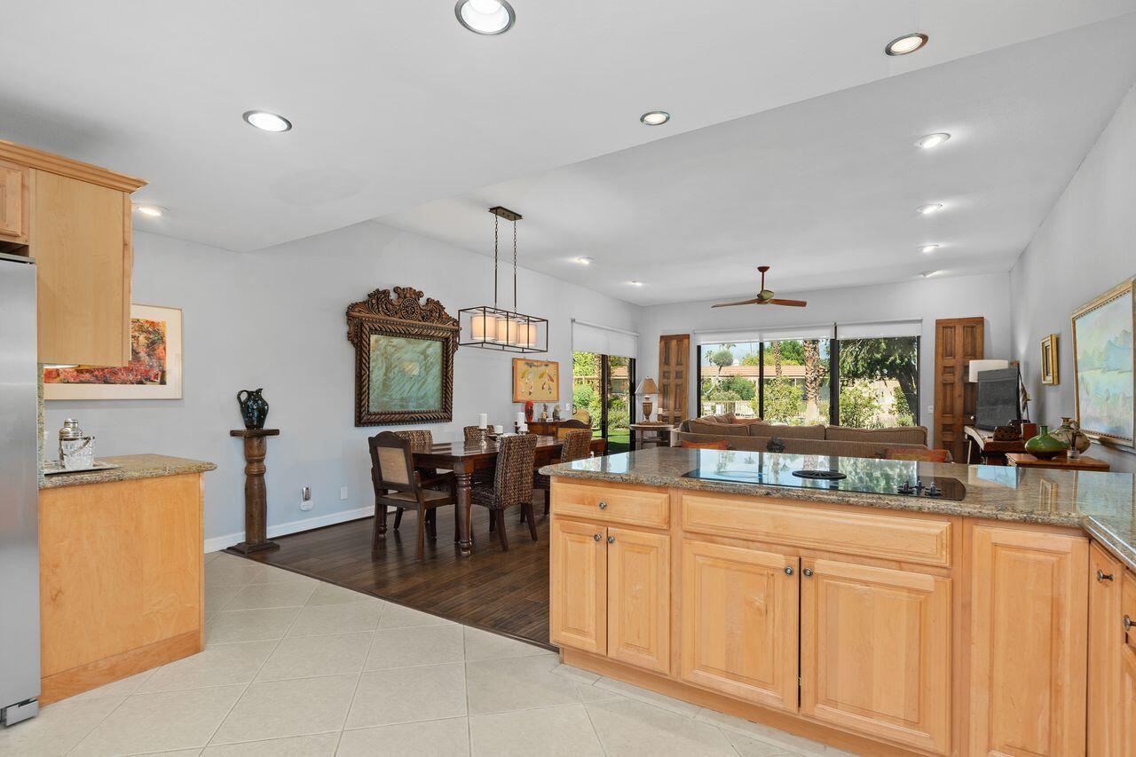 45475 Pueblo Road Indian Wells, CA 92210 - Photo 12 of 30 an open kitchen with granite countertop a stove and white cabinets