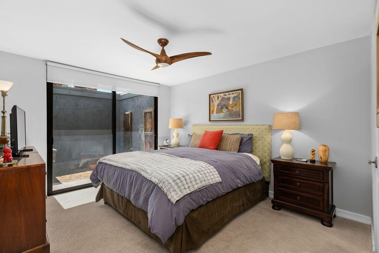 45475 Pueblo Road Indian Wells, CA 92210 - Photo 17 of 30 a spacious bedroom with a bed and a walk in closet