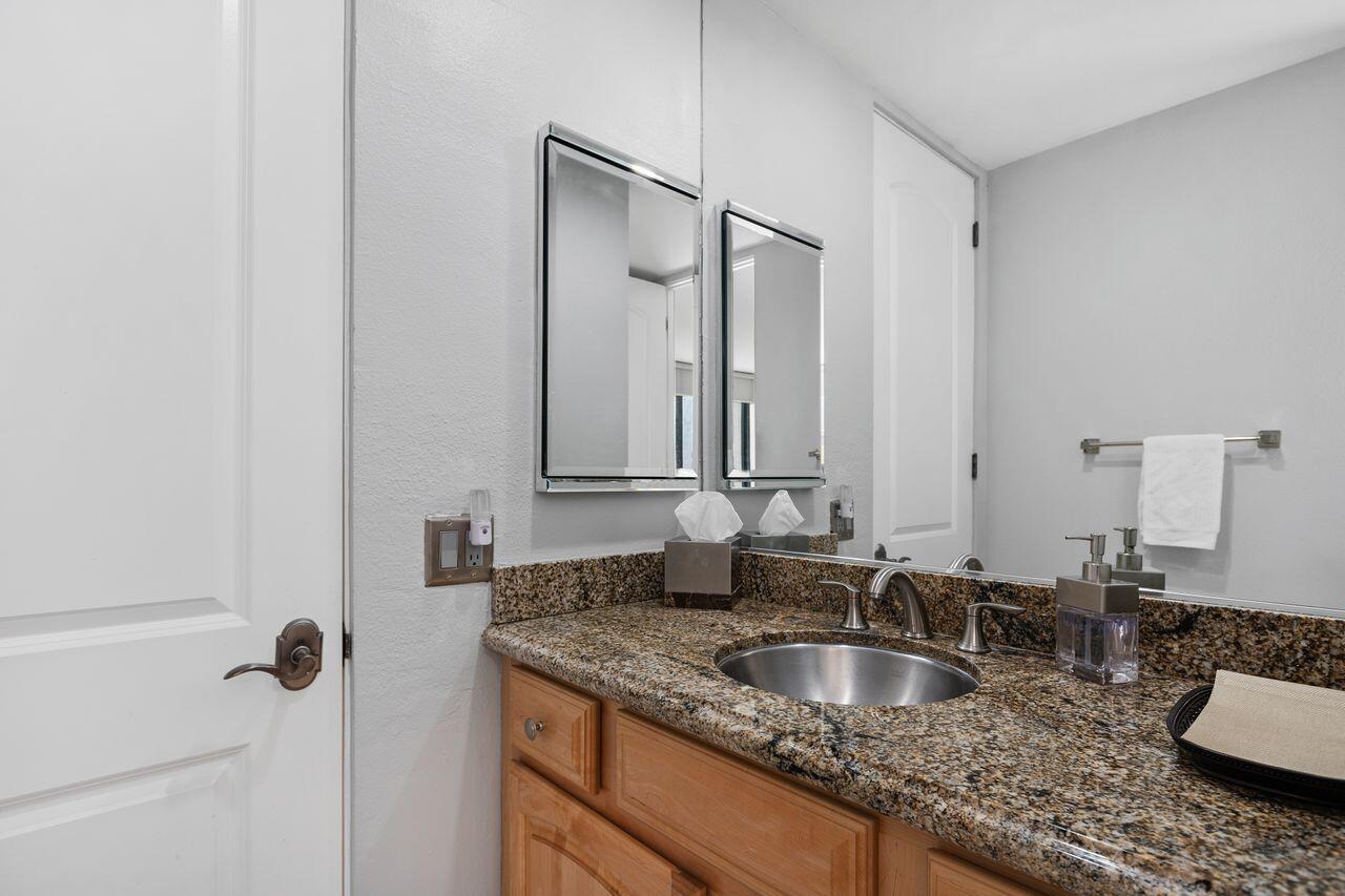 45475 Pueblo Road Indian Wells, CA 92210 - Photo 19 of 30 a bathroom with a granite countertop sink and a mirror