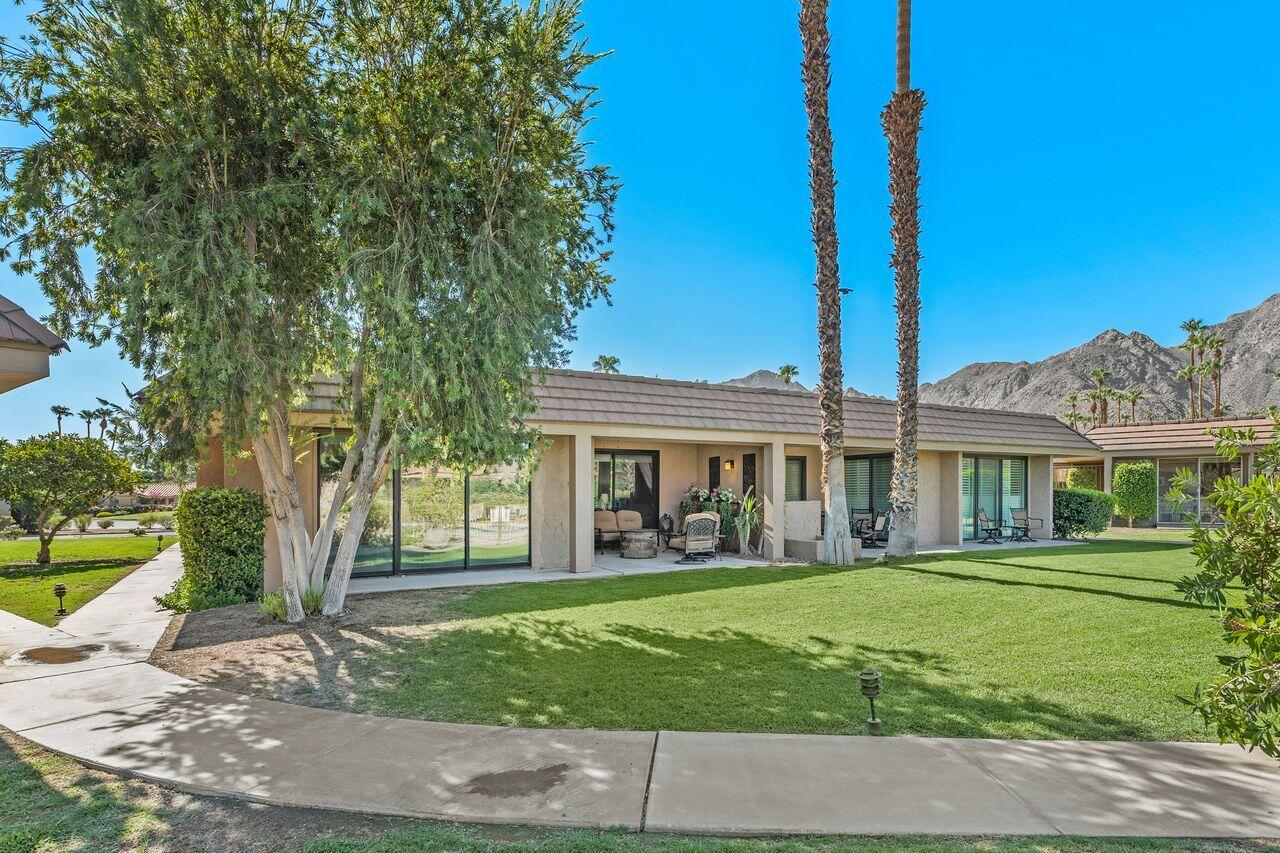 45475 Pueblo Road Indian Wells, CA 92210 - Photo 26 of 30 a front view of a house with a garden