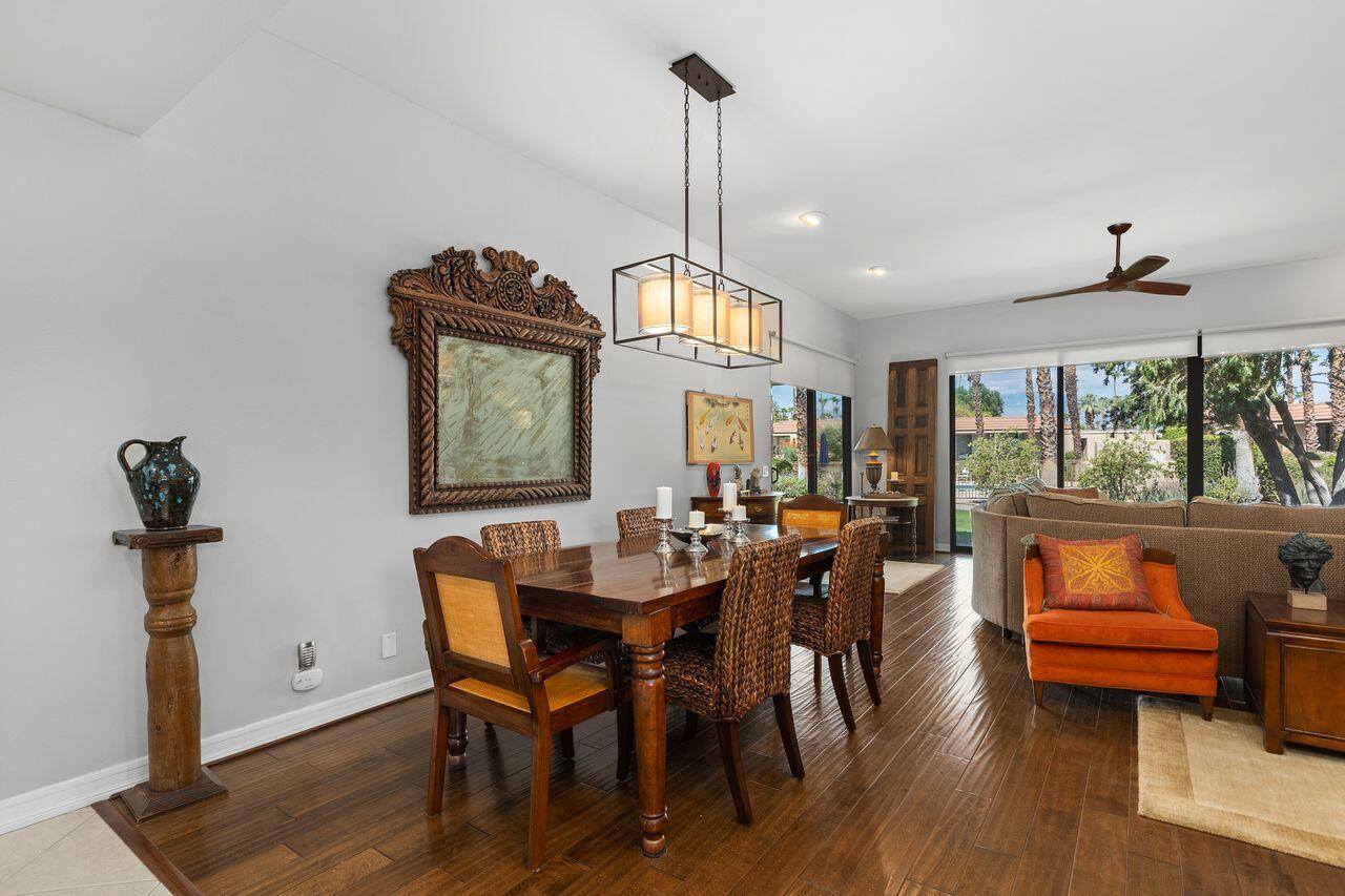 45475 Pueblo Road Indian Wells, CA 92210 - Photo 4 of 30 a dining room with furniture a chandelier and wooden floor