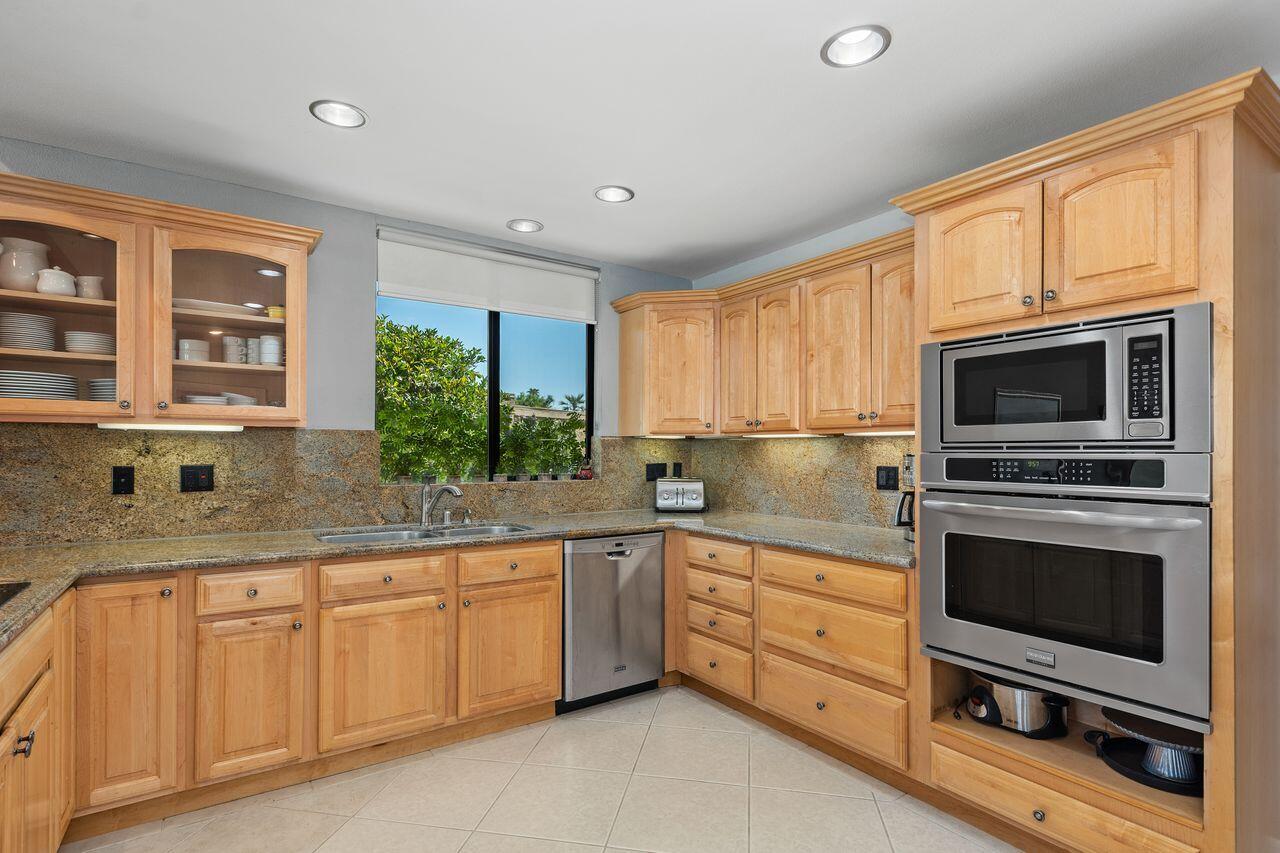 45475 Pueblo Road Indian Wells, CA 92210 - Photo 5 of 30 a kitchen with granite countertop a sink stainless steel appliances and cabinets