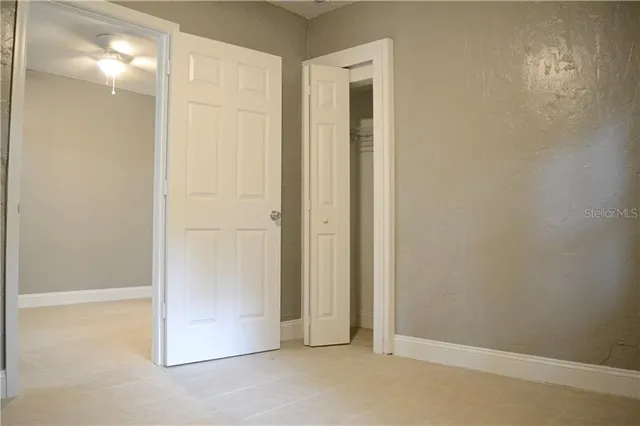 a view of staircase with white walls and white door