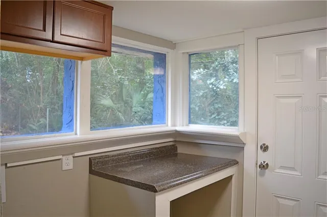 a view of a hallway with wooden shelves