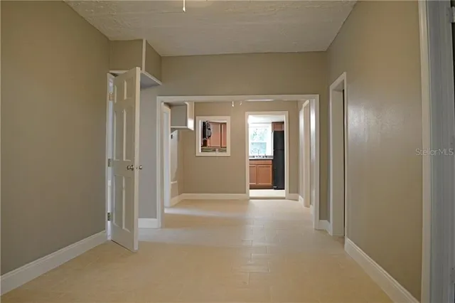 a bathroom with a granite countertop bathtub shower sink vanity and toilet