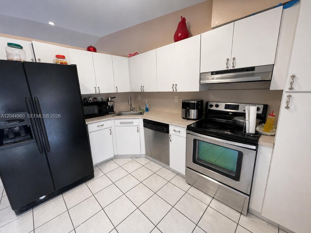 7681 Northwest 178th Terrace Hialeah, FL 33015 - Photo 6 of 11 a kitchen with a sink appliances and cabinets