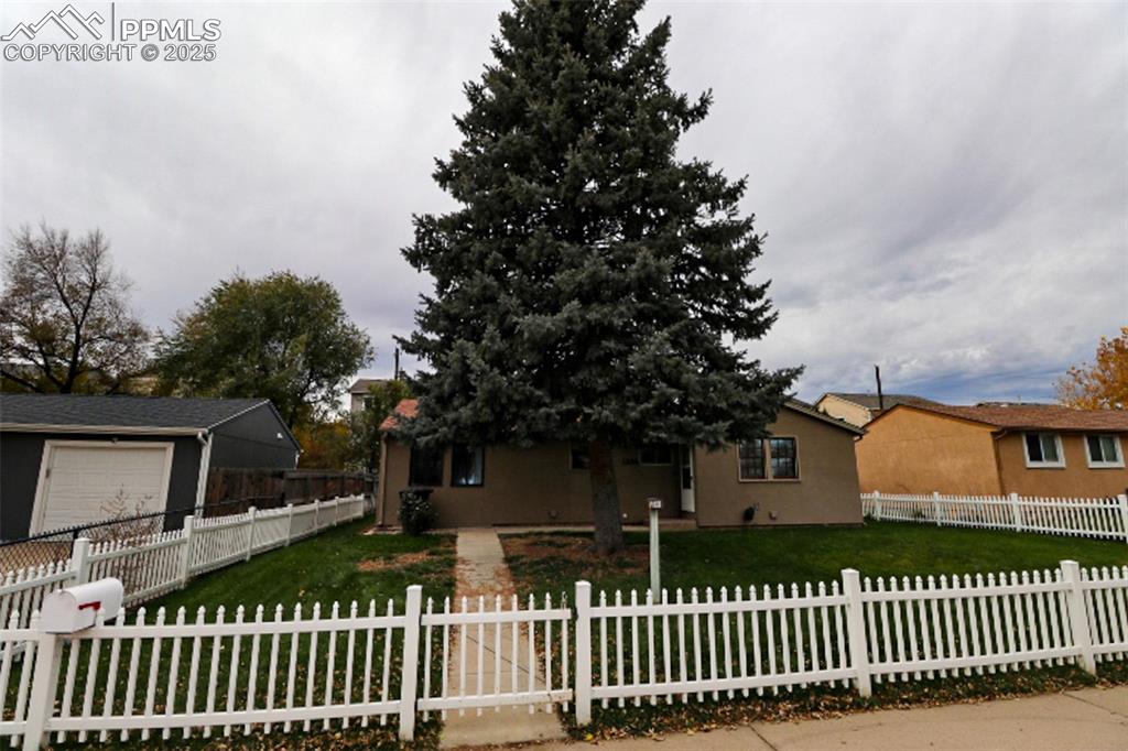 1206 Hartford Street Colorado Springs, CO 80906 - Photo 1 of 24 a front view of a house with a garden