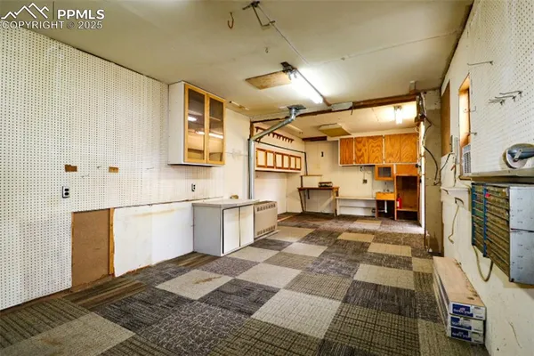 a large white kitchen with stainless steel appliances granite countertop a sink and cabinets
