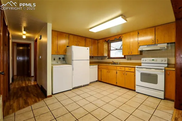 a utility room with cabinets washer and dryer
