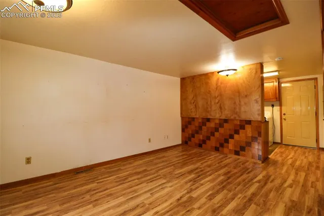 a view of a room with wooden floor