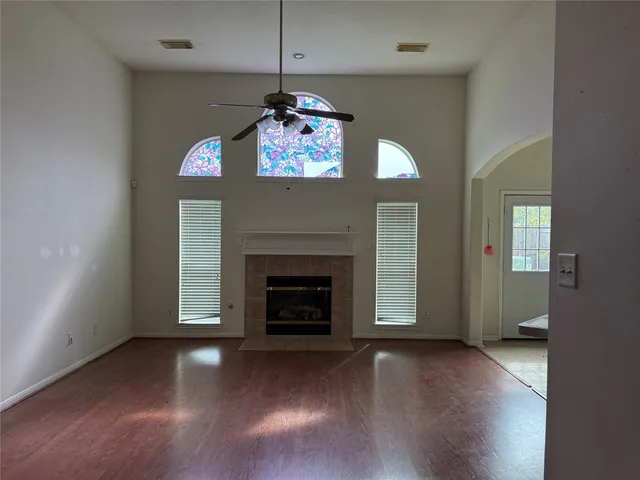 a view of an empty room with a fireplace and a window