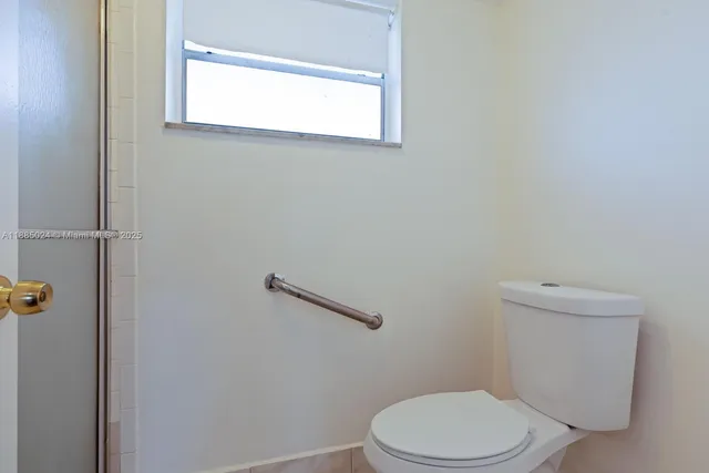a white toilet sitting next to a bathroom sink