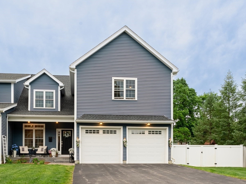 38 Cherry Street, Unit B Hudson, MA 01749 - Photo 1 of 33 a front view of a house with garden
