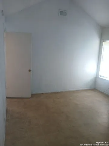 a view of an empty room and a window