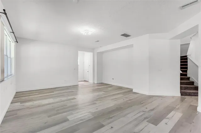 wooden floor in an empty room with a window