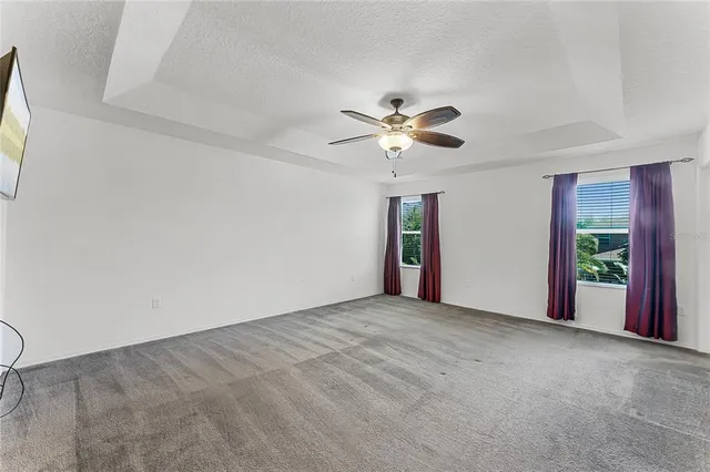 a view of a livingroom with an empty space and a ceiling fan
