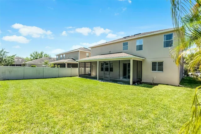 a view of a house with a backyard