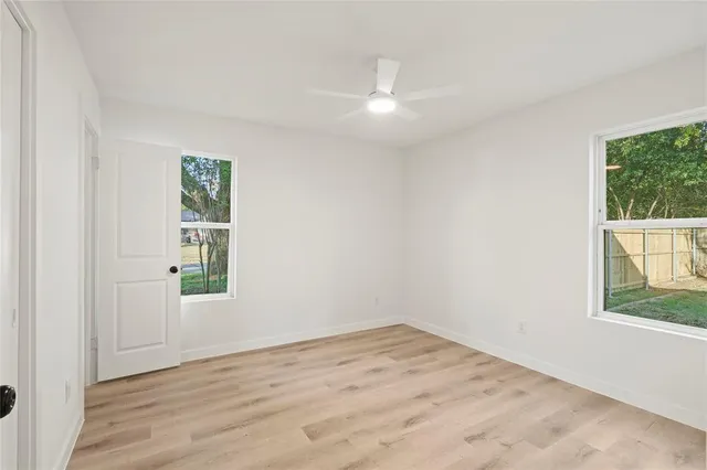 wooden floor in an empty room with a window