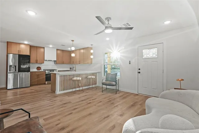 a living room with stainless steel appliances kitchen island granite countertop furniture and a kitchen view