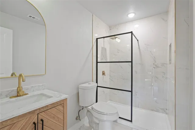 a bathroom with a sink toilet and shower