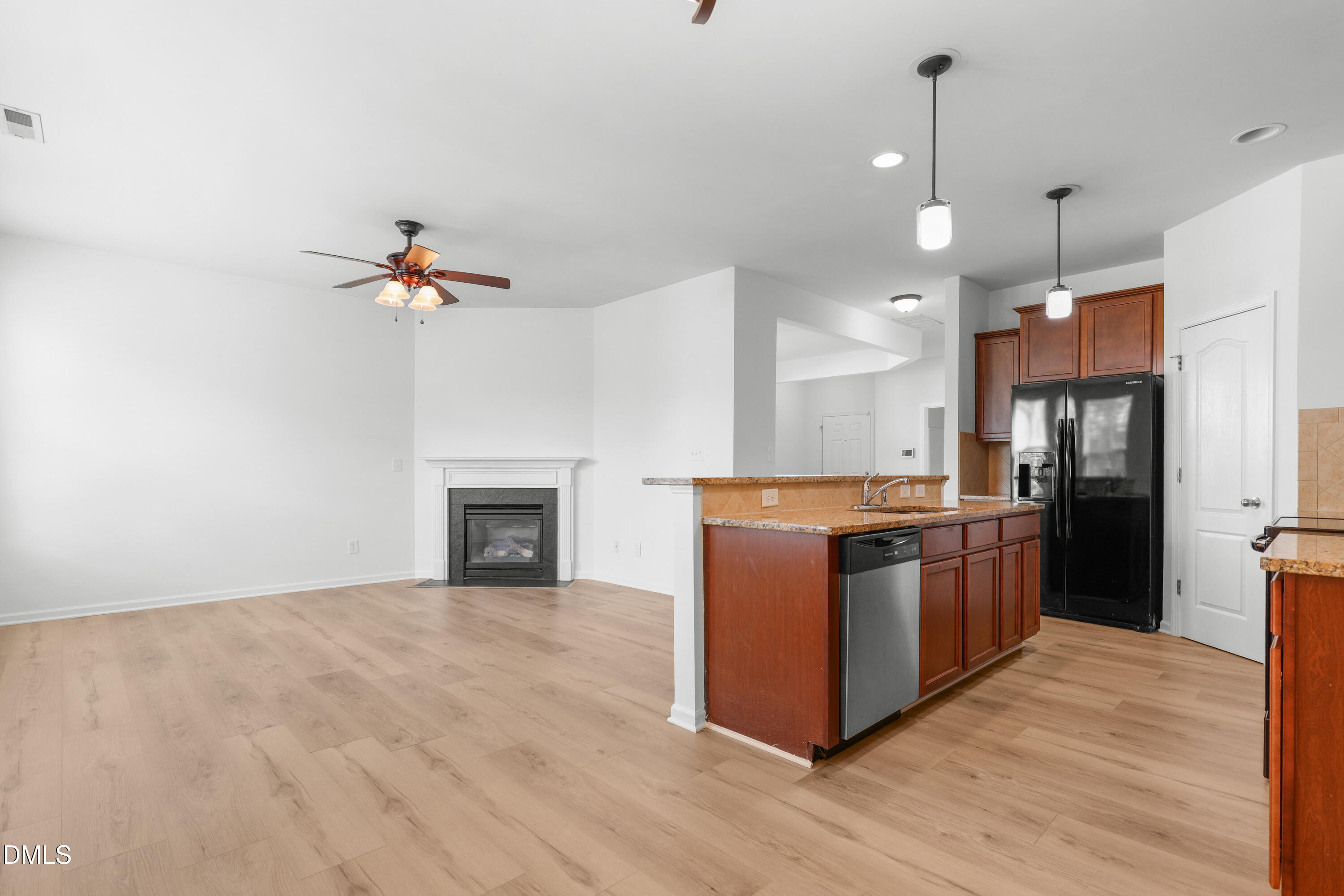 4400 Hillsgrove Road Wake Forest, NC 27587 - Photo 11 of 49 a kitchen with stainless steel appliances granite countertop a refrigerator a stove a sink and a wooden floors