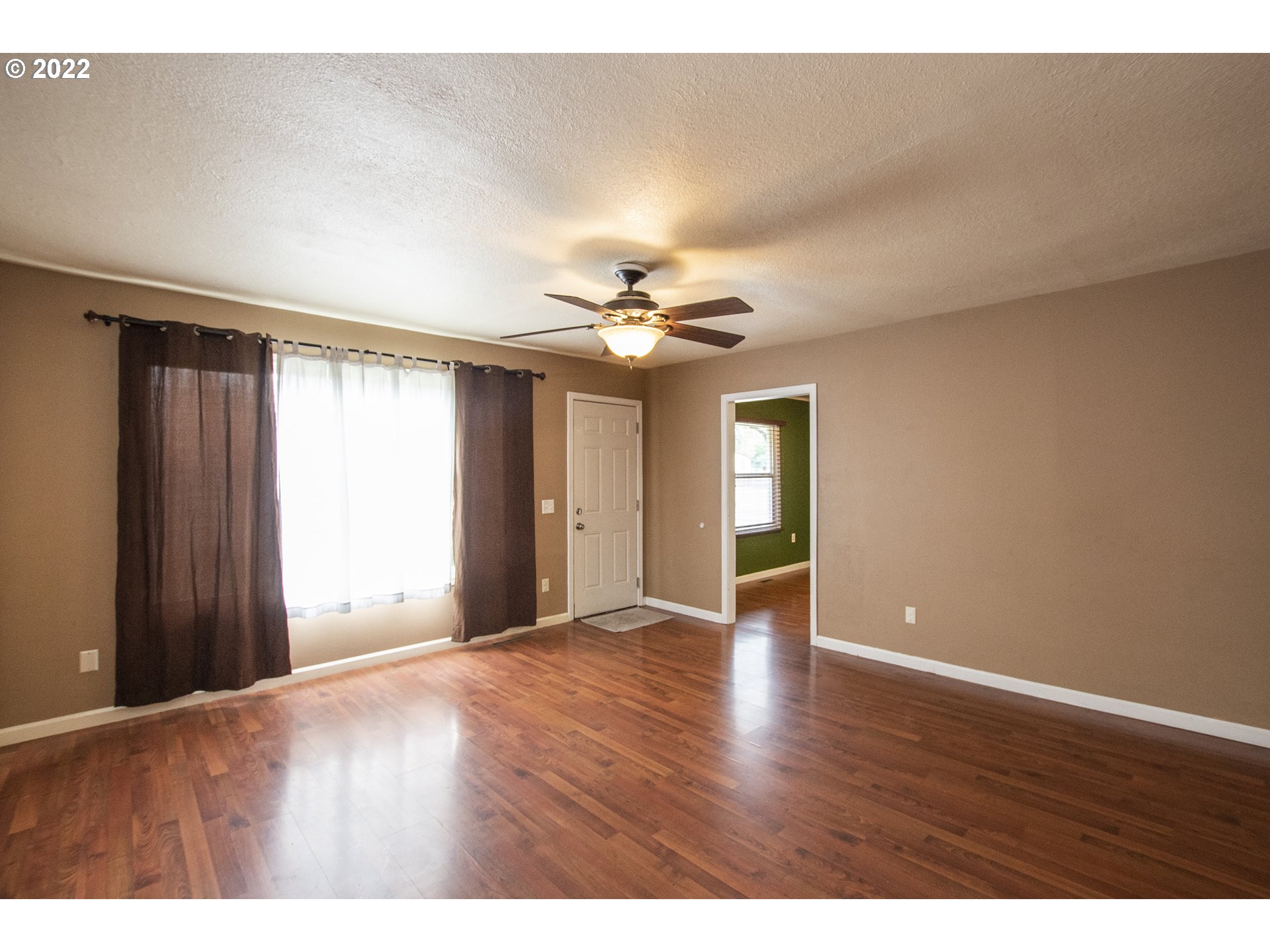 388 South 46th Street Springfield, OR 97478 - Photo 5 of 22 a view of an empty room with window and wooden floor