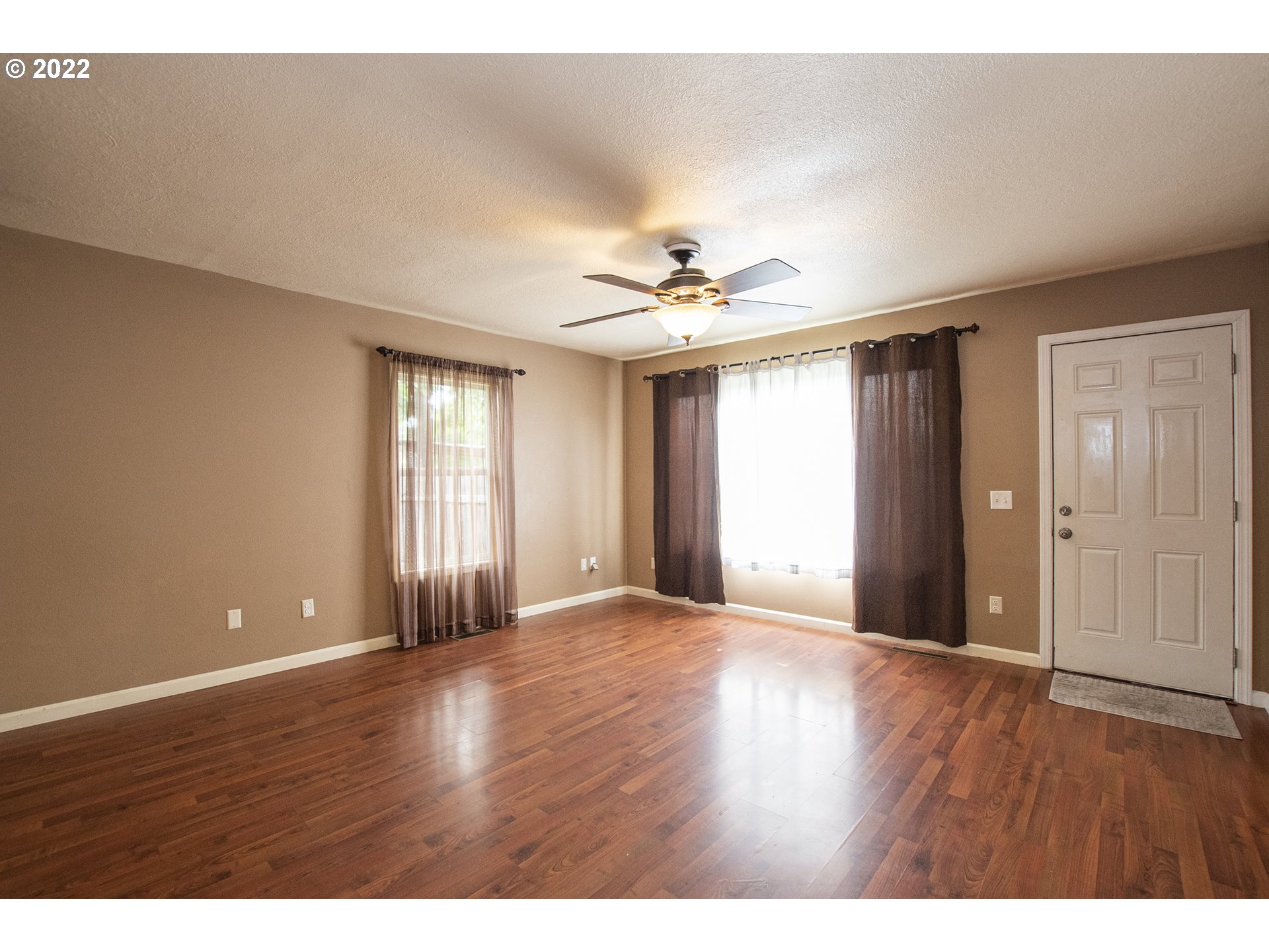 388 South 46th Street Springfield, OR 97478 - Photo 6 of 22 a view of an empty room with window and wooden floor