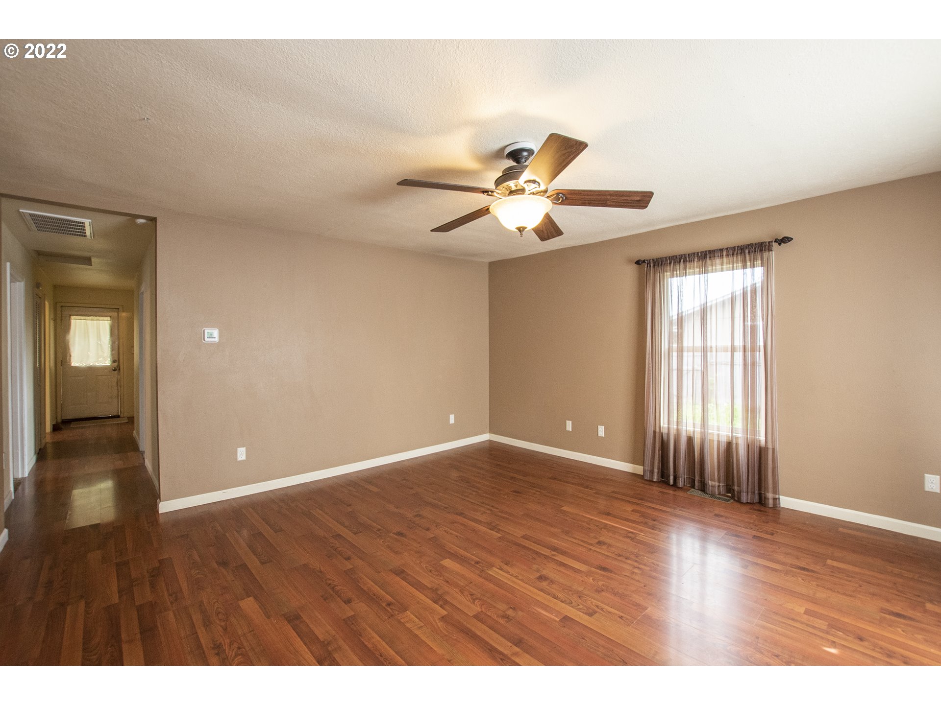 388 South 46th Street Springfield, OR 97478 - Photo 7 of 22 a view of an empty room with window and wooden floor