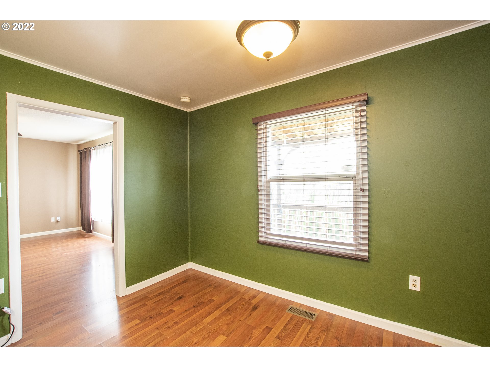 388 South 46th Street Springfield, OR 97478 - Photo 8 of 22 a view of an empty room with wooden floor and a window
