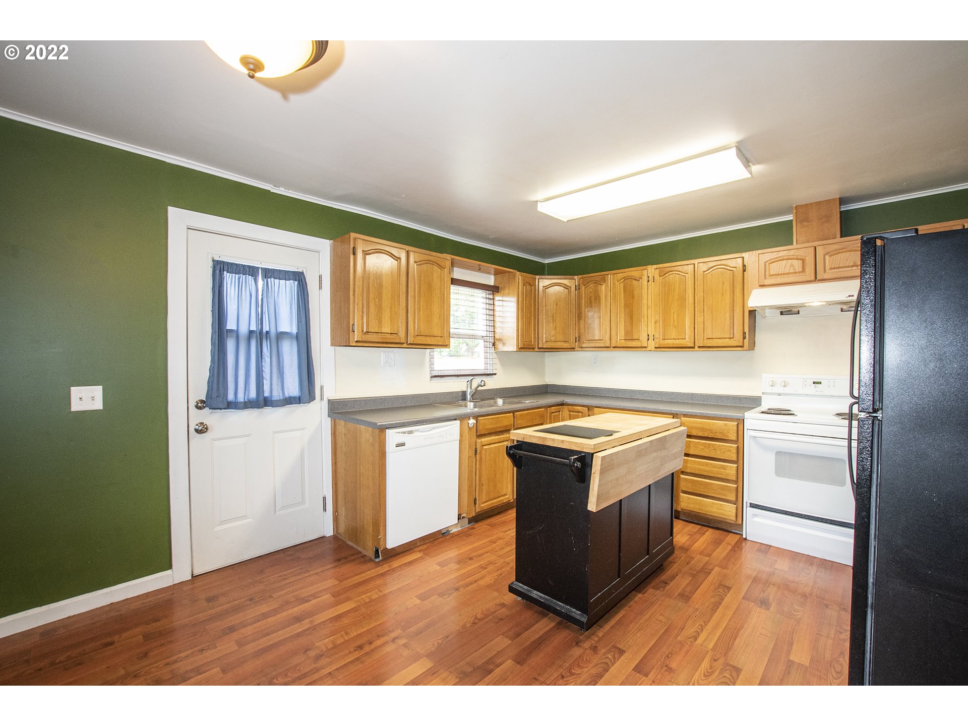388 South 46th Street Springfield, OR 97478 - Photo 9 of 22 a kitchen with a refrigerator and a stove top oven