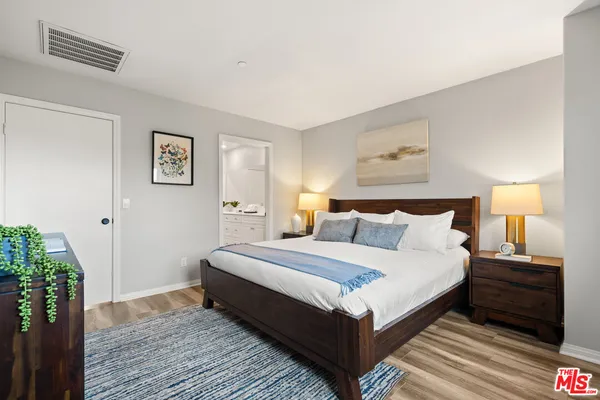 a bedroom with a bed and a night stand