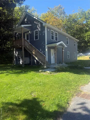 a front view of house with yard and green space