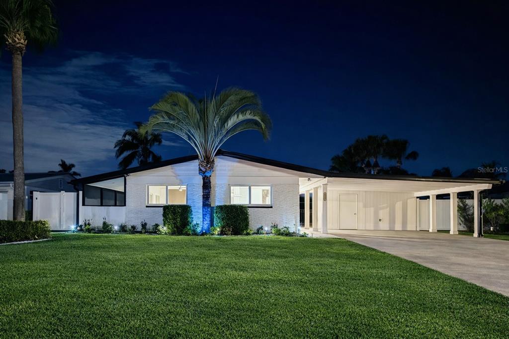 a front view of a house with a garden
