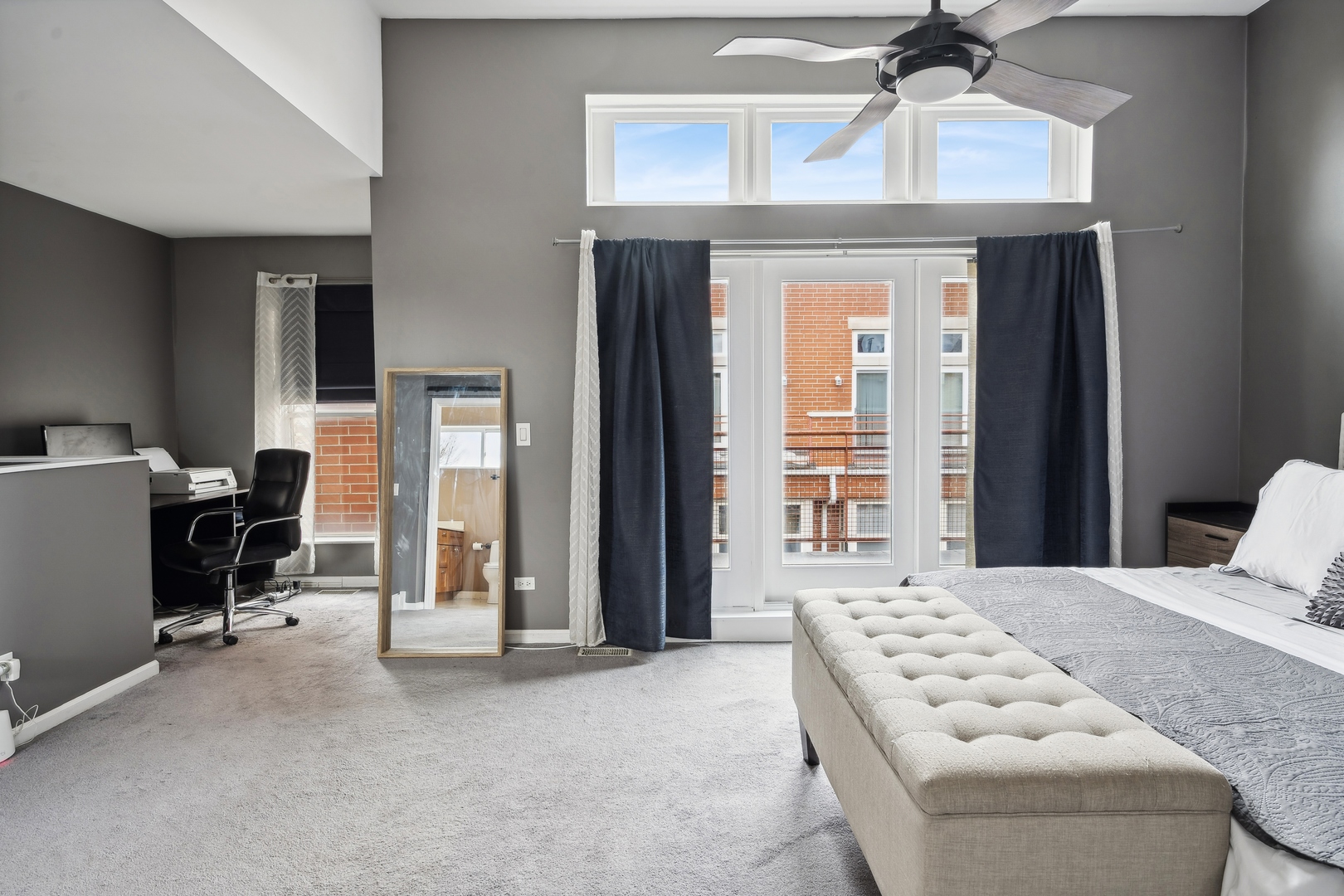 3337 West Irving Park Road, Unit 5 Chicago, IL 60618 - Photo 11 of 20 a bedroom with a bed and a chandelier
