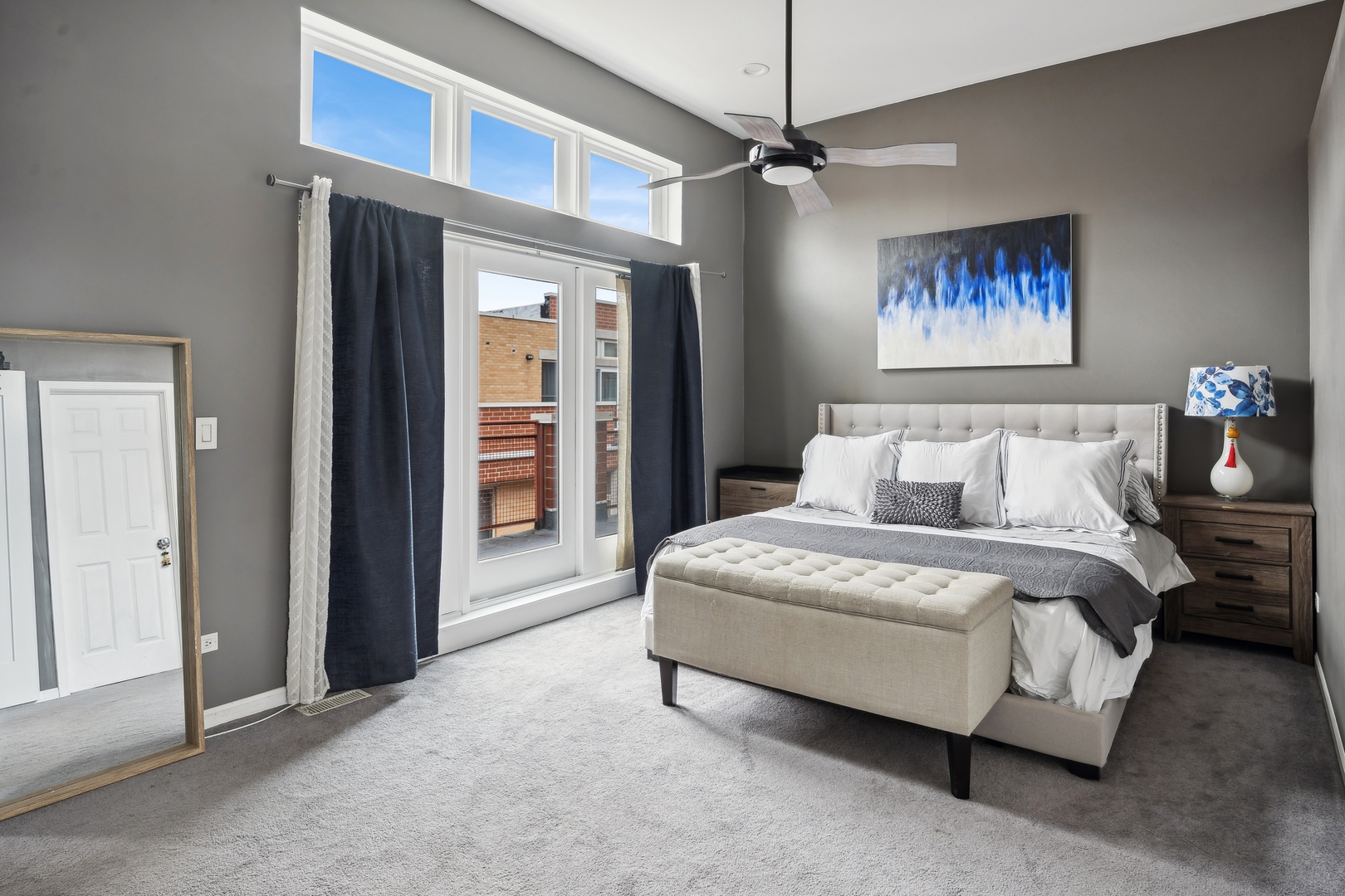 3337 West Irving Park Road, Unit 5 Chicago, IL 60618 - Photo 12 of 20 a spacious bedroom with a bed and a chandelier