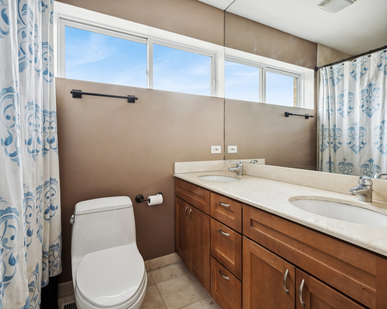 3337 West Irving Park Road, Unit 5 Chicago, IL 60618 - Photo 13 of 20 a bathroom with a granite countertop toilet sink and mirror