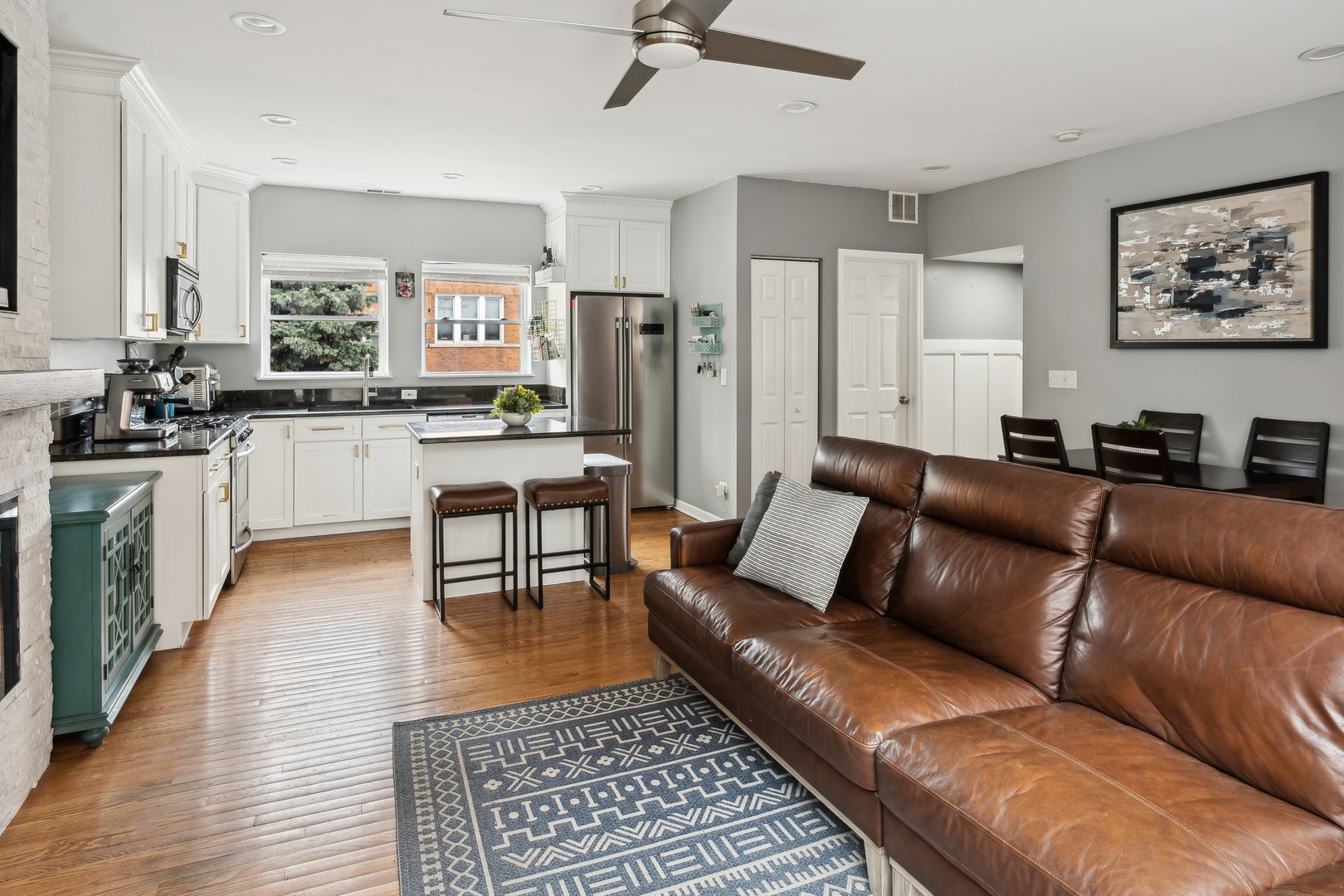 3337 West Irving Park Road, Unit 5 Chicago, IL 60618 - Photo 6 of 20 a living room with stainless steel appliances furniture and a kitchen view