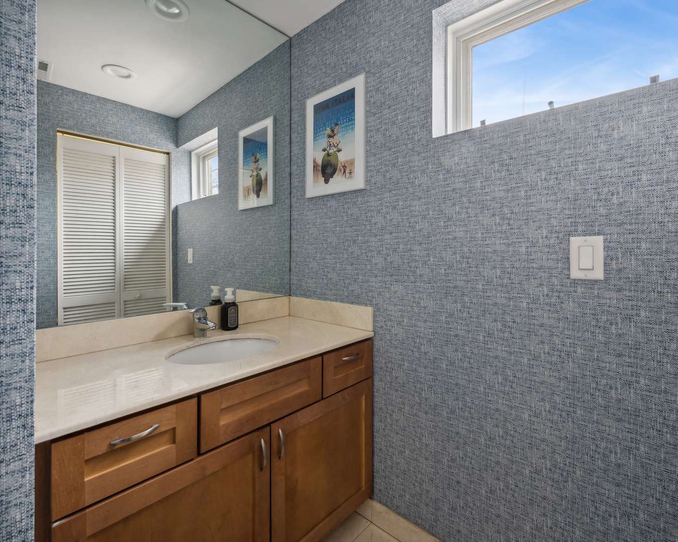 3337 West Irving Park Road, Unit 5 Chicago, IL 60618 - Photo 7 of 20 a bathroom with a granite countertop sink and a mirror