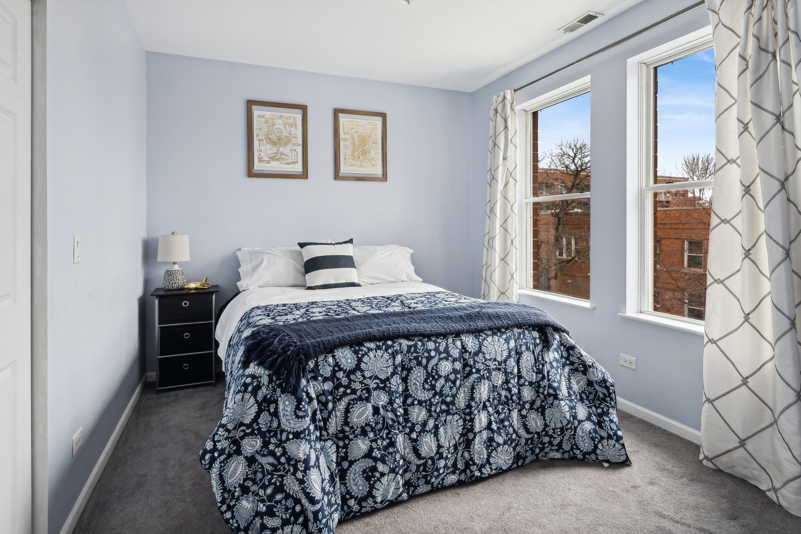 3337 West Irving Park Road, Unit 5 Chicago, IL 60618 - Photo 8 of 20 a bedroom with a bed and a window