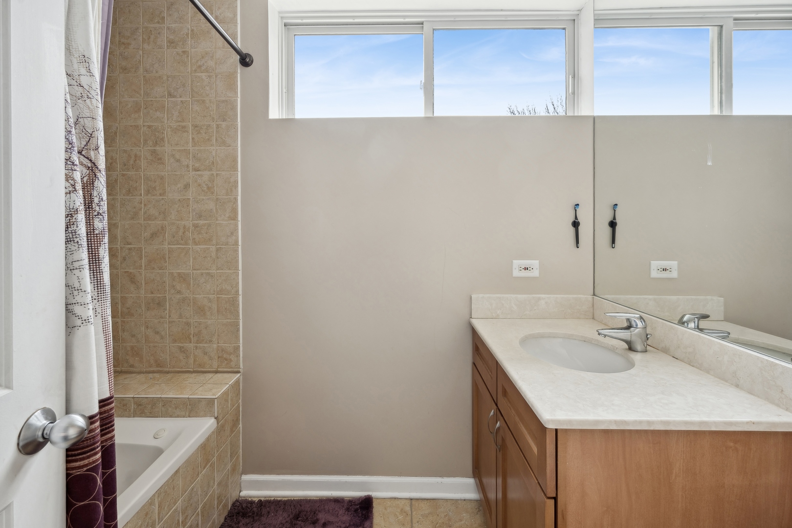 3337 West Irving Park Road, Unit 5 Chicago, IL 60618 - Photo 10 of 20 a bathroom with a sink and a bathtub