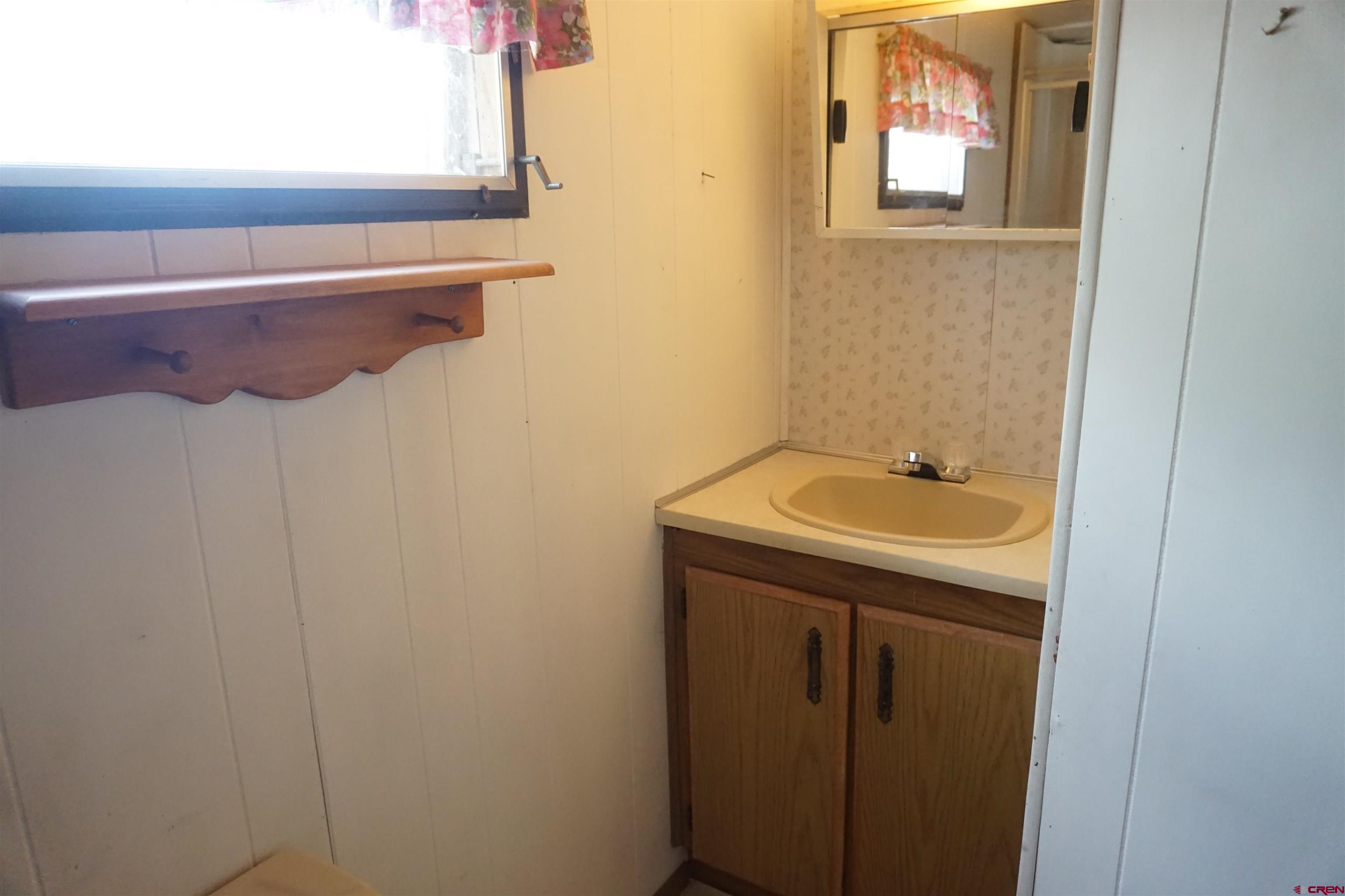 60497 Maple Grove Road Montrose, CO 81403 - Photo 11 of 16 a bathroom with a sink and mirror