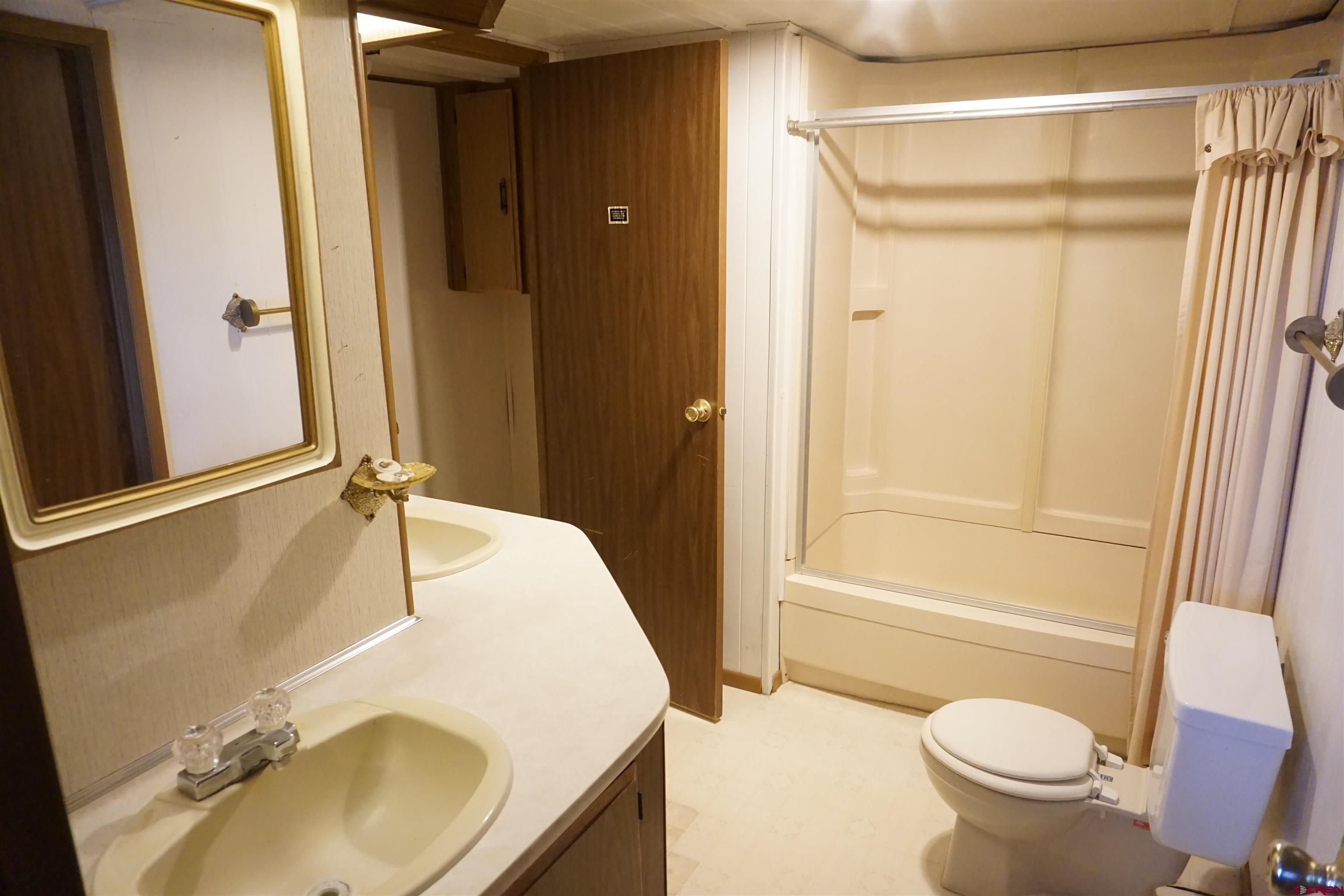60497 Maple Grove Road Montrose, CO 81403 - Photo 13 of 16 a bathroom with a sink toilet and shower