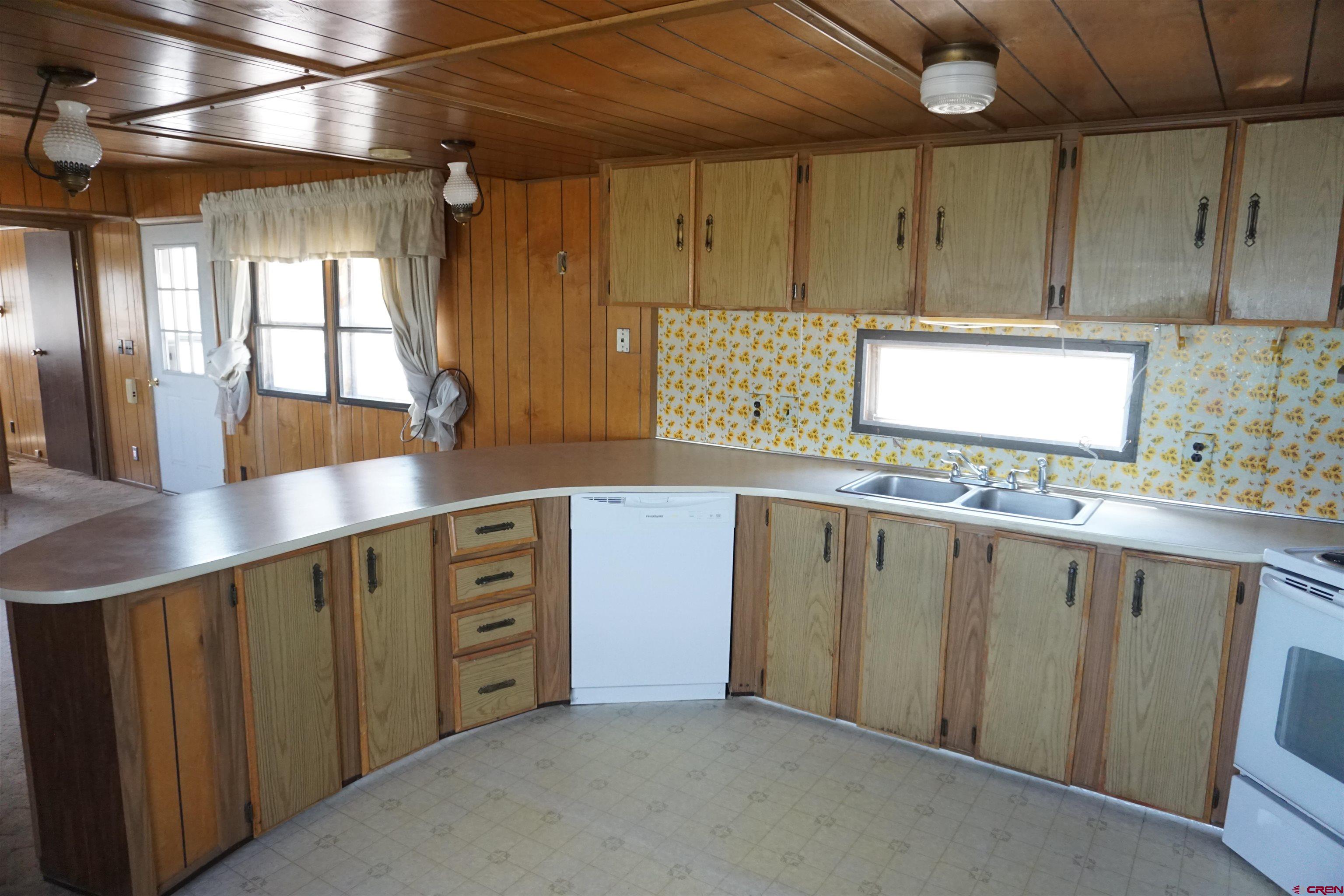 60497 Maple Grove Road Montrose, CO 81403 - Photo 6 of 16 a kitchen with stainless steel appliances a sink and cabinets